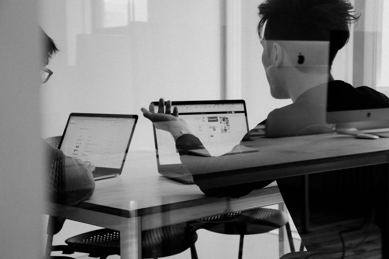 A marketer comparing influencer marketing platforms on a laptop at a desk